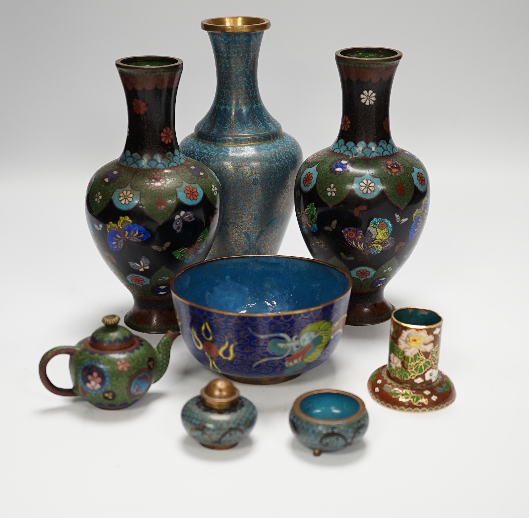 A collection of Chinese and Japanese cloisonné enamel pieces, including five vases, a ginger jar and cover, three bowls, a miniature teapot, napkin rings, etc. (19)